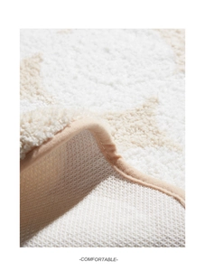 Macro detail of the plush cream tufted surface and non-slip backing of this soft home rug