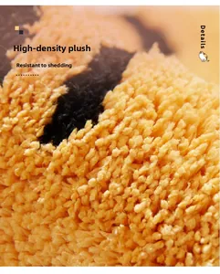Detail view of high-density orange and black plush bath mat with durable fiber texture