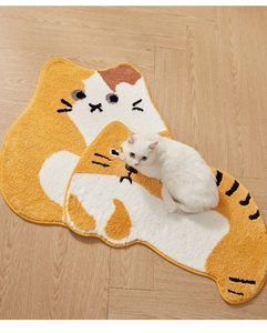 Detail of soft high-density cat-shaped plush mats with non-slip texture on wood floor