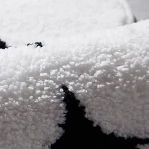 Plush cream-style irregular rug with soft fluffy black and white fibers for living rooms