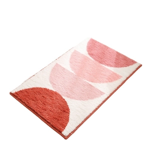 Absorbent cream-style bathroom rug with pink geometric semicircles and plush texture