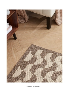 Detailed close-up of geometric semi-circle woven polypropylene rug with non-slip texture