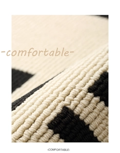 Macro shot showing the thick knit texture and geometric pattern of the entry door mat