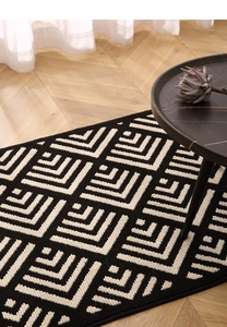 Detailed macro view of black and white checkered tufted texture on a vintage style doormat