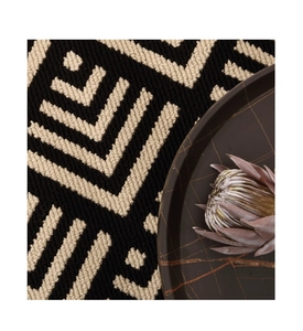 Macro shot of black and white geometric arrow pattern woven texture on a luxury doormat