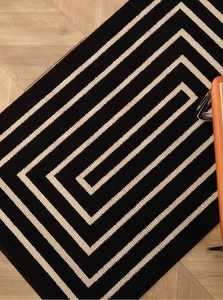 Detail view of woven geometric spiral pattern on a durable rectangular entryway floor mat