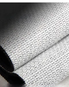 Macro detail of the non-slip backing with triangle texture on home entrance door mat