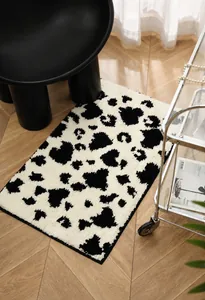 Detailed view of rectangle cow print plush bathroom rug on high-quality wood floor