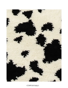 Detailed macro view of soft cow print faux fur texture for bathroom floor mats