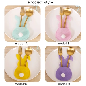 Easter rabbit felt cutlery holders in four pastel colors on plates for table decor