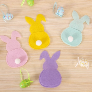 Easter felt rabbit cutlery holders in macaron colors displayed on a light wooden background