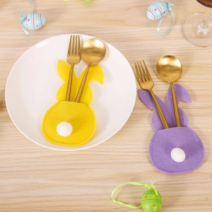 Detailed view of yellow and purple rabbit felt cutlery holders for Easter table decor