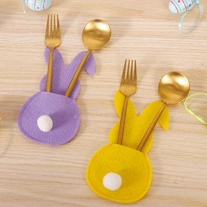 Close-up of Easter rabbit felt cutlery holders with plush balls and metal forks