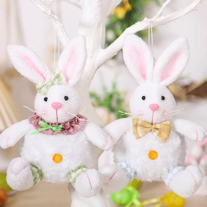 Close-up of plush white Easter bunny charms with green and yellow plaid bow ties