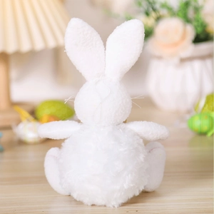 Close-up of a white plush Easter bunny with long ears and a soft pom-pom tail