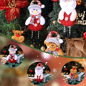 Detailed view of Christmas dolls with linen fabric and red plaid hats for tree decor