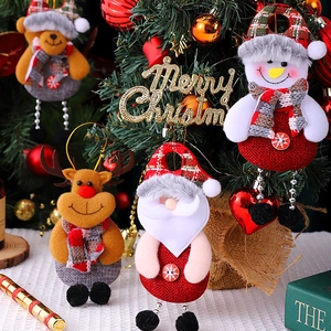 Close-up of Santa, Snowman, Reindeer, and Bear linen plush Christmas ornaments on a tree