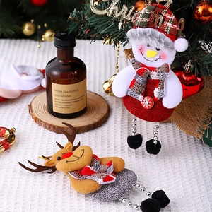 Detailed view of Christmas linen dolls featuring snowman and reindeer with beaded legs