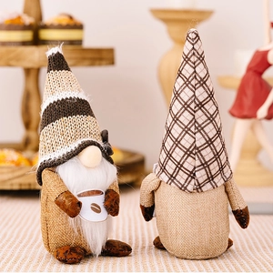 Detail of two handmade coffee gnomes with burlap hats and white beards for cafe decor