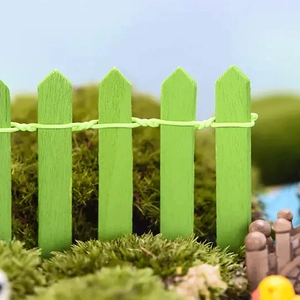 Macro shot of miniature green wood fence with flexible wire for DIY fairy garden decor