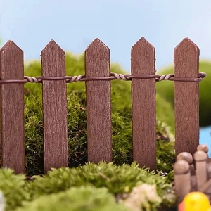 Detailed view of dark brown wood fence with moss and miniature ducks for DIY decor