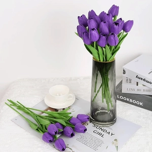 Detail of purple PU tulips in a grey striped glass vase for elegant home decor