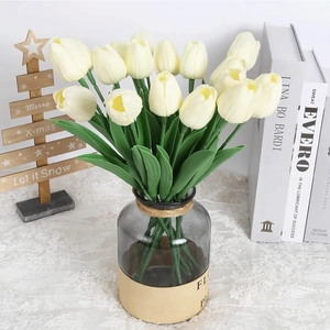 Realistic creamy white PU tulips in a clear glass vase with twine and lace cloth