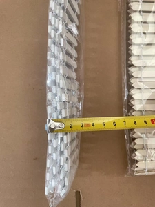 Close-up measurement of white wooden fence pieces for micro landscapes with yellow tape