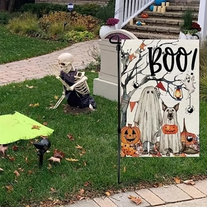 Close-up of Halloween garden flag featuring ghosts and pumpkins on a metal stand
