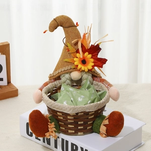 Detail of fall gnome figurine holding a woven basket with candies and sunflower decorations