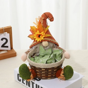 Close-up of autumn gnome with orange knitted hat and small wicker basket for candy
