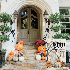 Outdoor Halloween garden flag with ghost, pumpkin and dog icons on a decorative metal pole