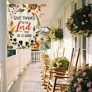 Detail of linen garden flag with autumn maple leaves and religious Give Thanks text