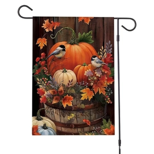 Detail of garden flag with pumpkin and bird illustrations on a black metal holder