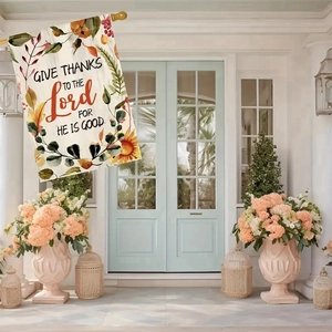 Detail of linen garden flag with autumn maple leaves and religious Give Thanks text