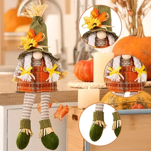 Fall harvest gnome decoration with green hat and maple leaves on a cozy kitchen counter