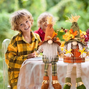 Pair of autumn Thanksgiving gnomes with maple leaf hats and striped long legs for decor