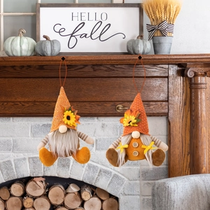 Close-up of autumn gnomes with maple leaf decor hanging in a cozy home setting