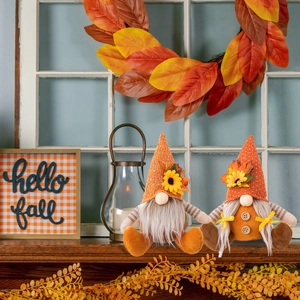 Autumn Thanksgiving gnomes set with orange knit hats and sunflower detail on wooden window sill