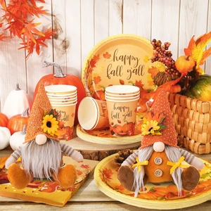 Detail of harvest gnomes with sunflowers and maple leaves on a rustic wood background