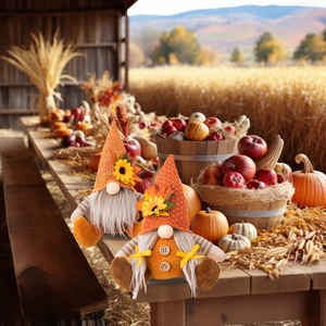 Close-up of harvest gnome plush set with sunflowers and maple leaves on knit hats