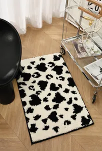 Close-up of thick plush cow print bathroom mat showing soft texture on wooden floor