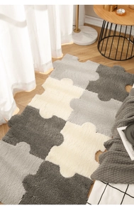 Detail of plush puzzle rugs in grey and white tones on a light wood floor