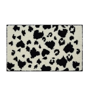 Absorbent rectangular bathroom mat with black and white dalmatian animal print texture