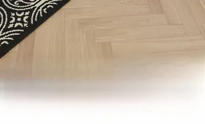 Detailed texture of black and white woven mandala kitchen mat on wood floor