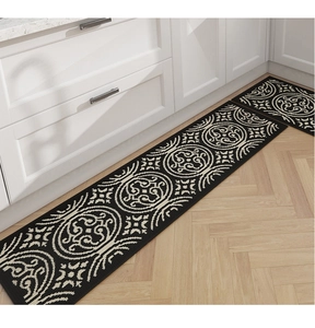 Detail of vintage mandala pattern kitchen mat on light wood floor with white cabinets