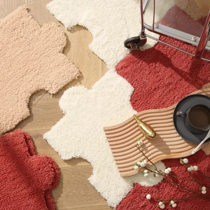 Modern puzzle shaped plush rug in cream and brick red colors for minimalist living room decor