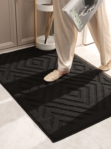 Macro shot of durable black entryway mat with geometric tufted patterns and premium texture