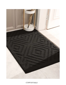 Detailed view of the black entry mat featuring thick 3D geometric diamond textures