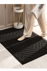 Detailed view of black geometric diamond textured entrance mat with embossed tufting